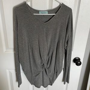 Long sleeve, gray sweater. Tied in front, long in back.